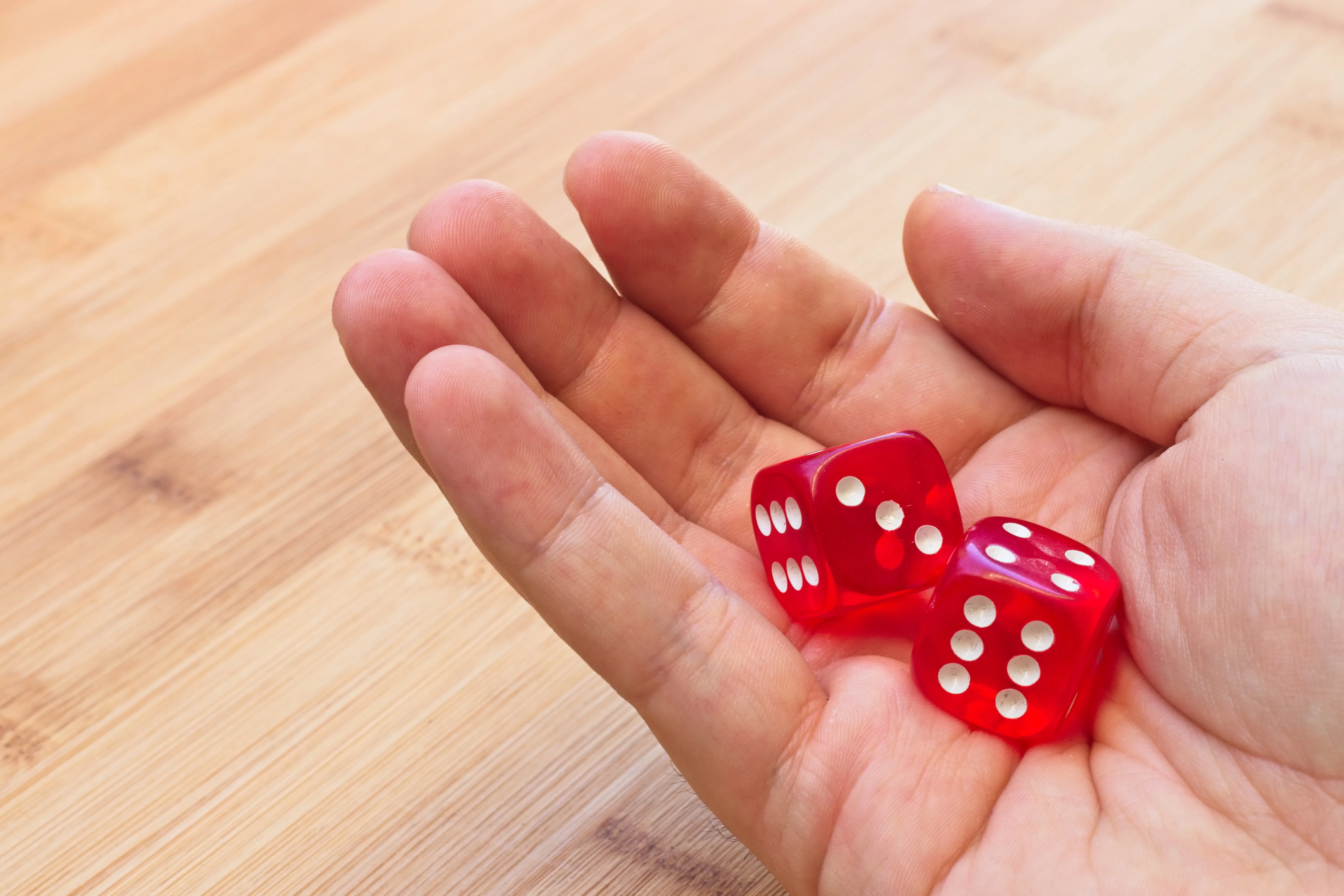 Two dice resting on a wooden surface